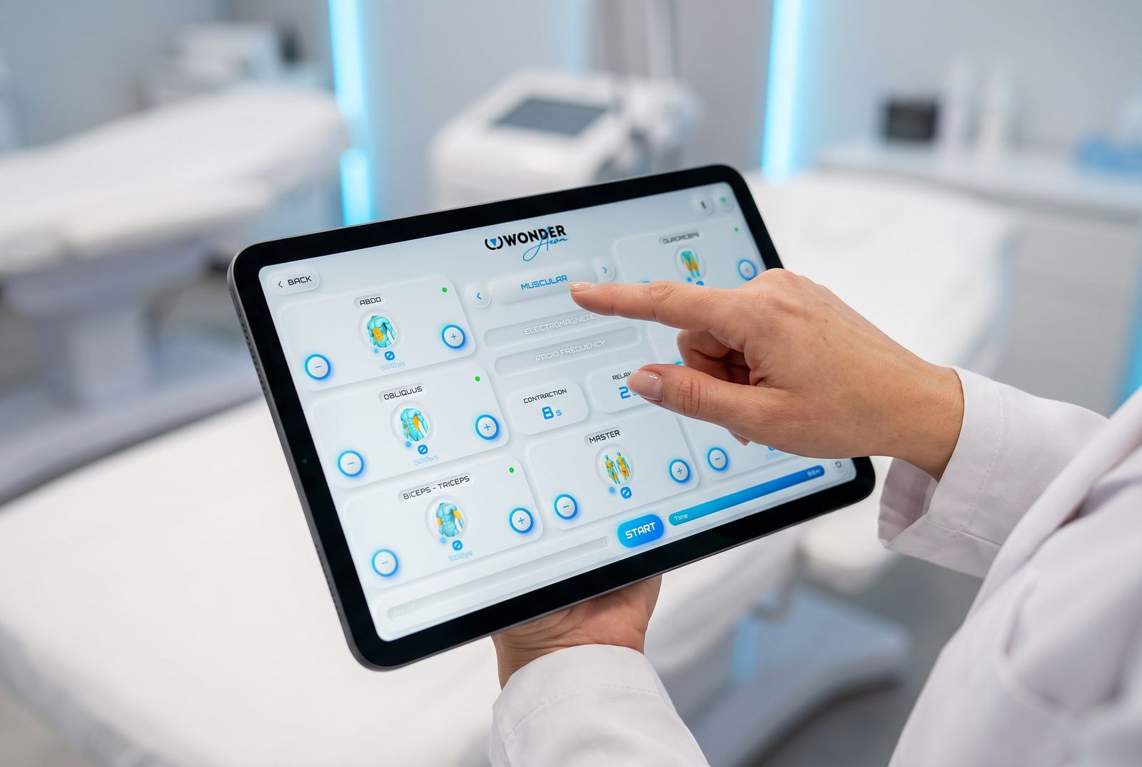 Close-up of a specialist's hand pointing at the Wonder Axon control screen on the tablet, showing the six muscle zones